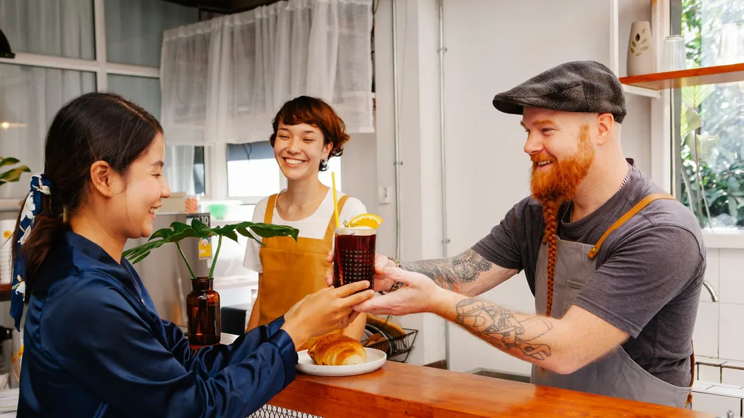 Cliente fiel sendo atendido por barista na cafeteria